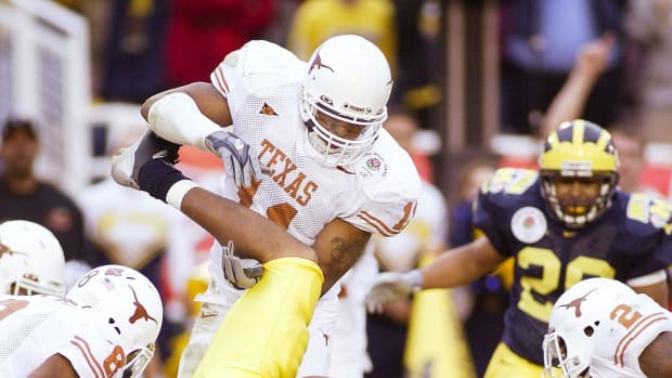 Jan 1, 2005; Pasadena, CA, USA: FILE PHOTO; Michigan Wolverines wide receiver Jermaine Gonzales (18) in action against Texas Longhorns cornerback Cedric Griffin (8) and linebacker Derrick Johnson (11) during the 2005 Rose Bowl at the Rose Bowl. The Longhorns defeated the Wolverines 38-37.